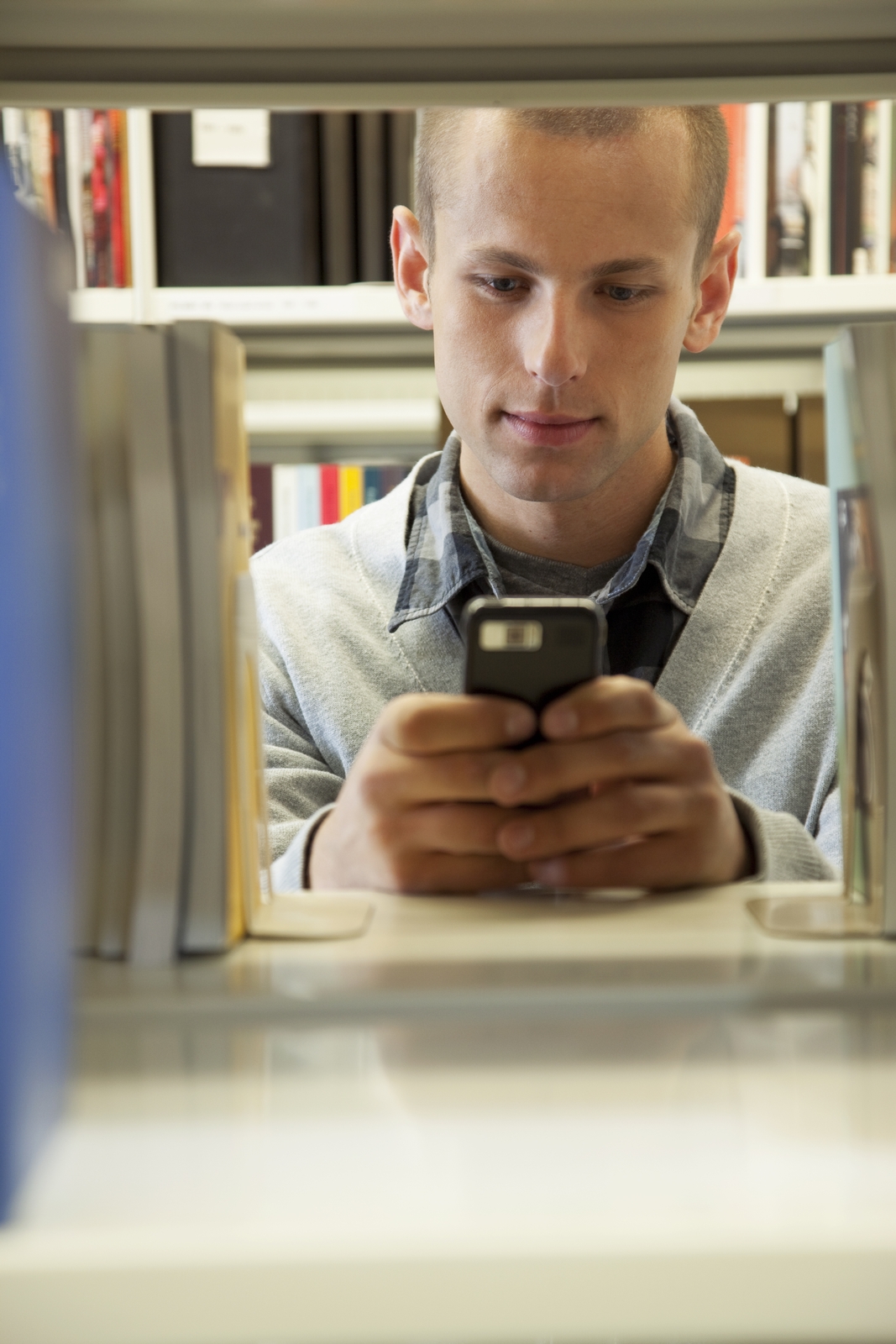 College Student on Phone in Library