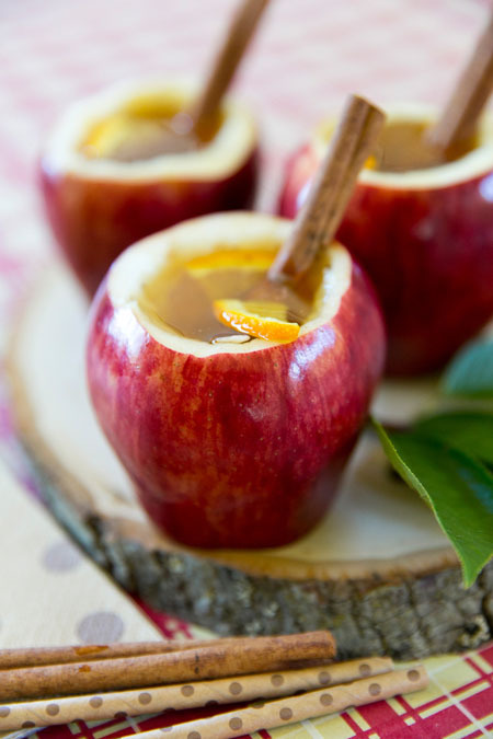 Cozy up this fall with a cup of easy homemade citrus apple cider in an edible apple cup and cinnamon drink stirrer!