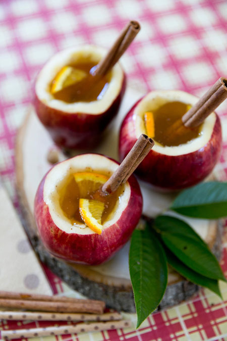 Cozy up this fall with a cup of easy homemade citrus apple cider in an edible apple cup and cinnamon drink stirrer!