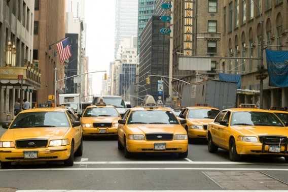 NEW YORK CITY, USA - March 15th, 2007, -Row of taxi cabs on Park Avenue with Waldorf Astoria hotel on background