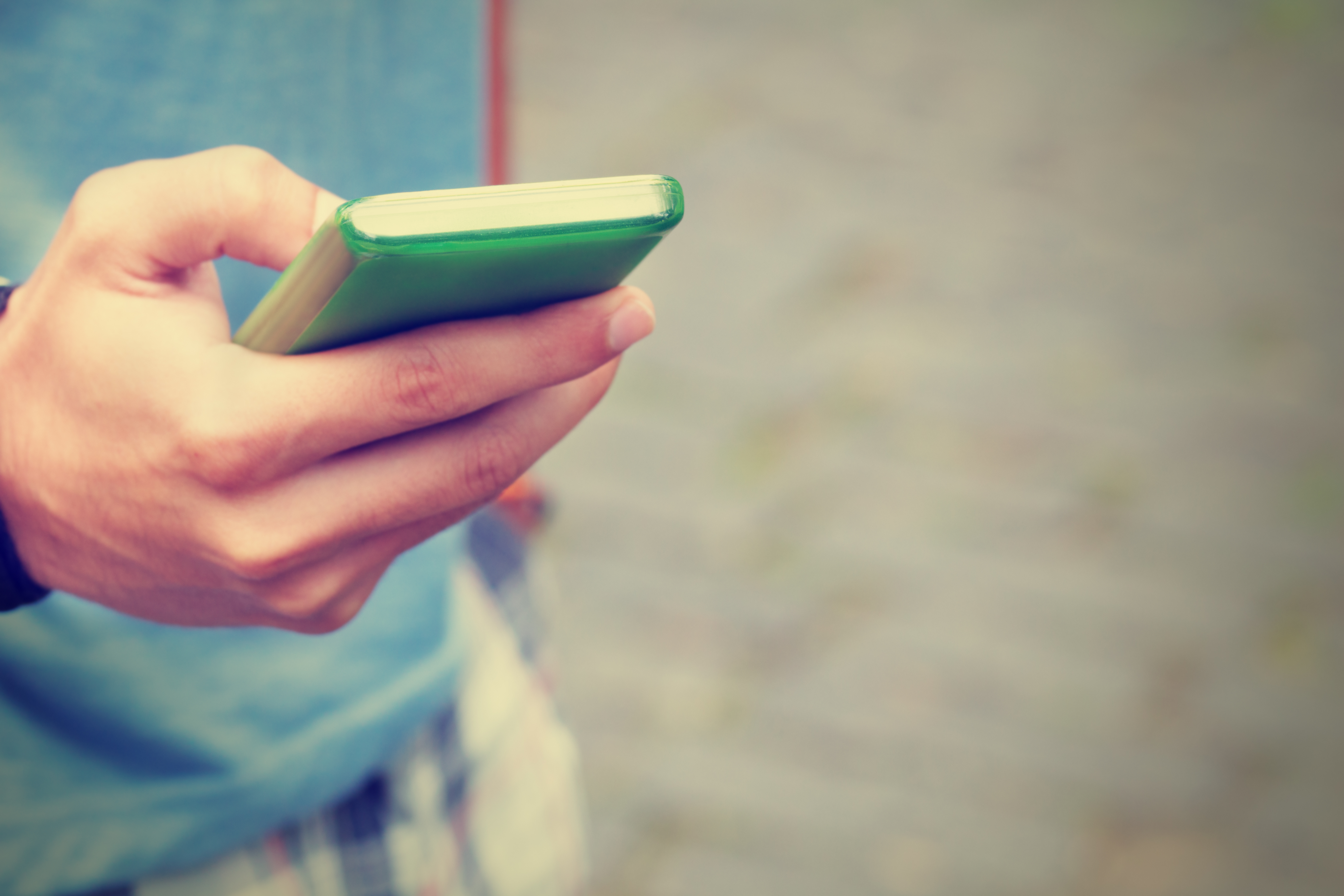 Typing messages on a smart-phone. Shallow depth of field.