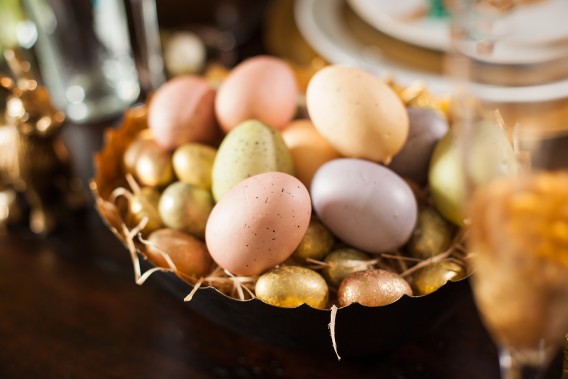 A simple centerpiece for your Easter table only requires decorative eggs, a bowl, and bunnies!