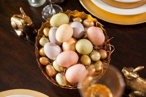 A simple centerpiece for your Easter table only requires decorative eggs, a bowl, and bunnies!