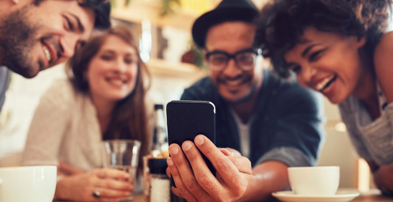 Group of people looking at mobile phone