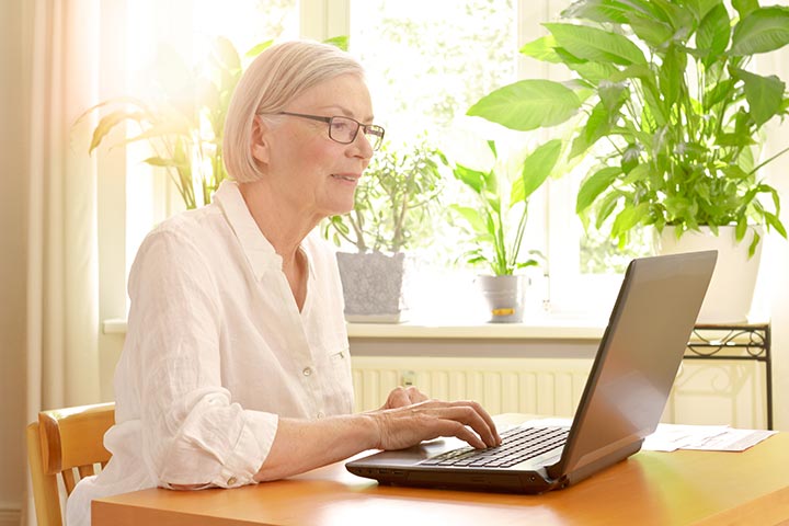 senior woman on computer, to illustrate looking for low-income senior housing