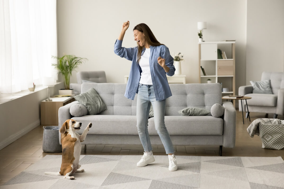 Renter plays with her pet in her apartment. 